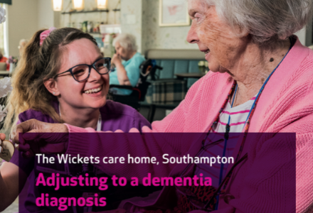 A picture of a nurse and service user at a care home for the Wickets event by Care UK in Southampton, Adjusting to a dementia diagnosis. The picture has the nurse smiling at the service user with a care home setting in the background.